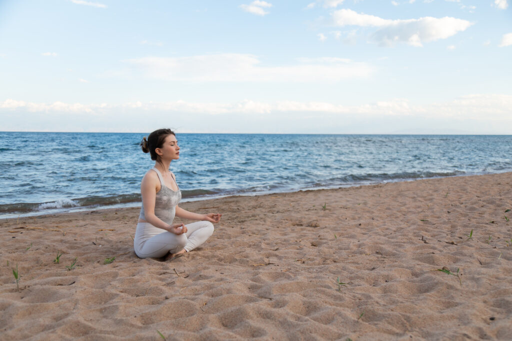 woman practicing yoga outside in lotus pose on bea 2025 03 30 00 39 32 utc